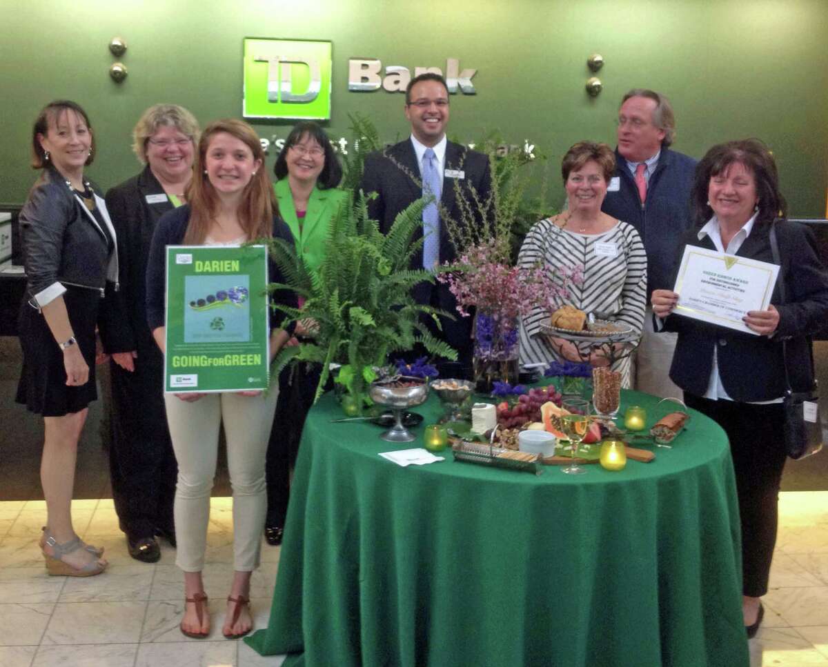 At the recent Darien Chamber of Commerce Going for Green awards event were, from left, Carol Wilder-Tamme, of the chamber; Paula Csengo, Darien branch manager of TD Bank; Amanda Bieler, runner-up in the poster contest; Kim Karl, TD Bank relationship manager; Gianni Dimeglio, TD Bank private client relationship manager; Dorine Bosler, Darien High School graphics arts instructor; Al Tibbetts, Tibbetts, Keating & Butler LLC and chairman of the chamber board; Carol Smith, award winner for the Darien Thrift Shop.