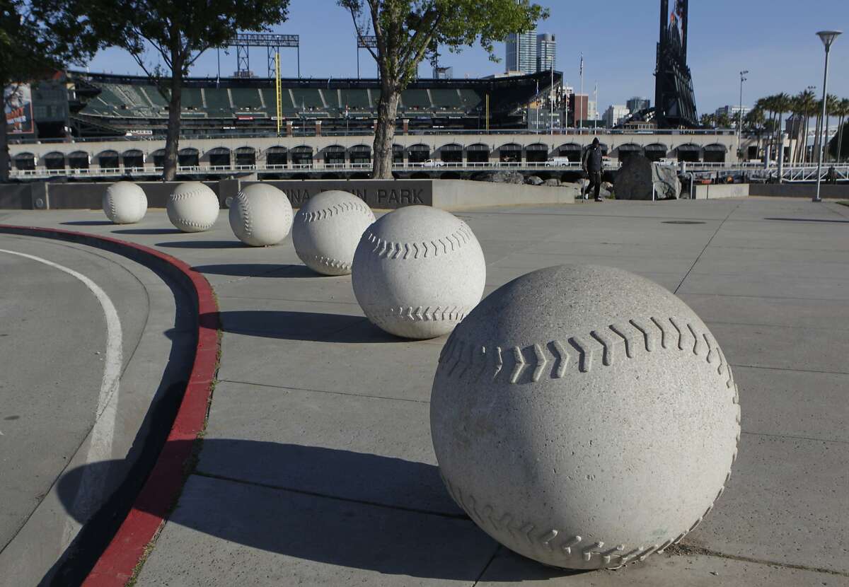 Baseball sculptures line the curb across from Lot A, near AT&T Park in San Francisco, Calif. on Tuesday, April 29, 2014. The Giants are proposing to build a large mixed-use community on the site, but the plans may be derailed if Prop. B, which would impose height limits on waterfront developments, is passed by voters.