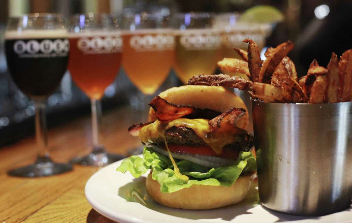 A bacon cheeseburger and french fries sit on the bar at the Blue Star Brewing Company on Tuesday, June 18, 2013.