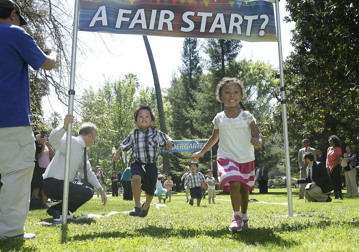 Madison Williams, 4, right, crosses the finish line ahead of Aiden Ha, 5, left, during a mock race among a group of preschool children Wednesday, April 8, 2014, a the Capitol in Sacramento, Calif. The race was held to promote the proposed legislation for Universal Pre-Kindergarten and Preschool authored by Senate President Pro Tem Darrell Steinberg, D-Sacramento, kneeling at left and Sen. Carol Liu, D-La Canada Flintridge, not pictured. Supporters of the "Kindergarten Readiness Act," say the bills would strengthen early language development and give low-income children a better start entering their first year of school. (AP Photo/Rich Pedroncelli)
