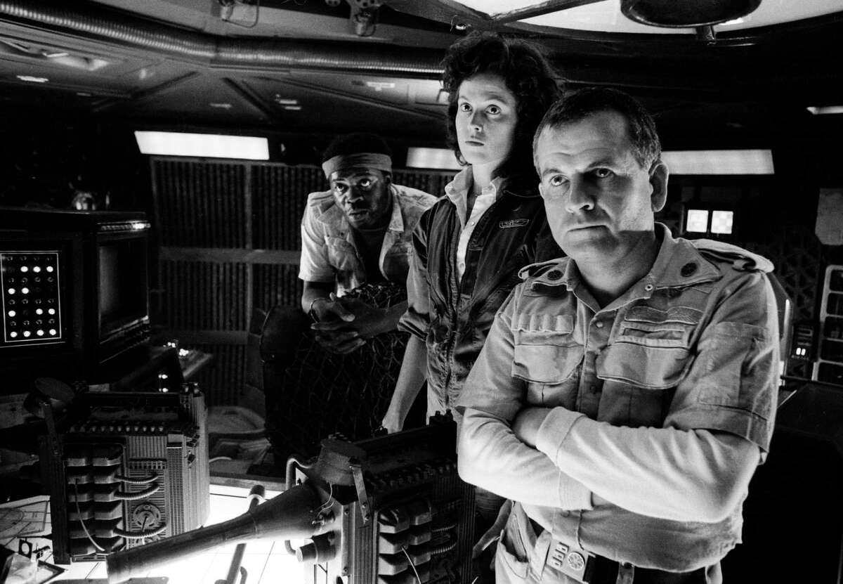 From left to right, actors Yaphet Kotto, Sigourney Weaver and Ian Holm on the set of Ridley Scott's science fiction classic 'Alien', circa 1979. (Photo by Terry O'Neill/Hulton Archive/Getty Images)