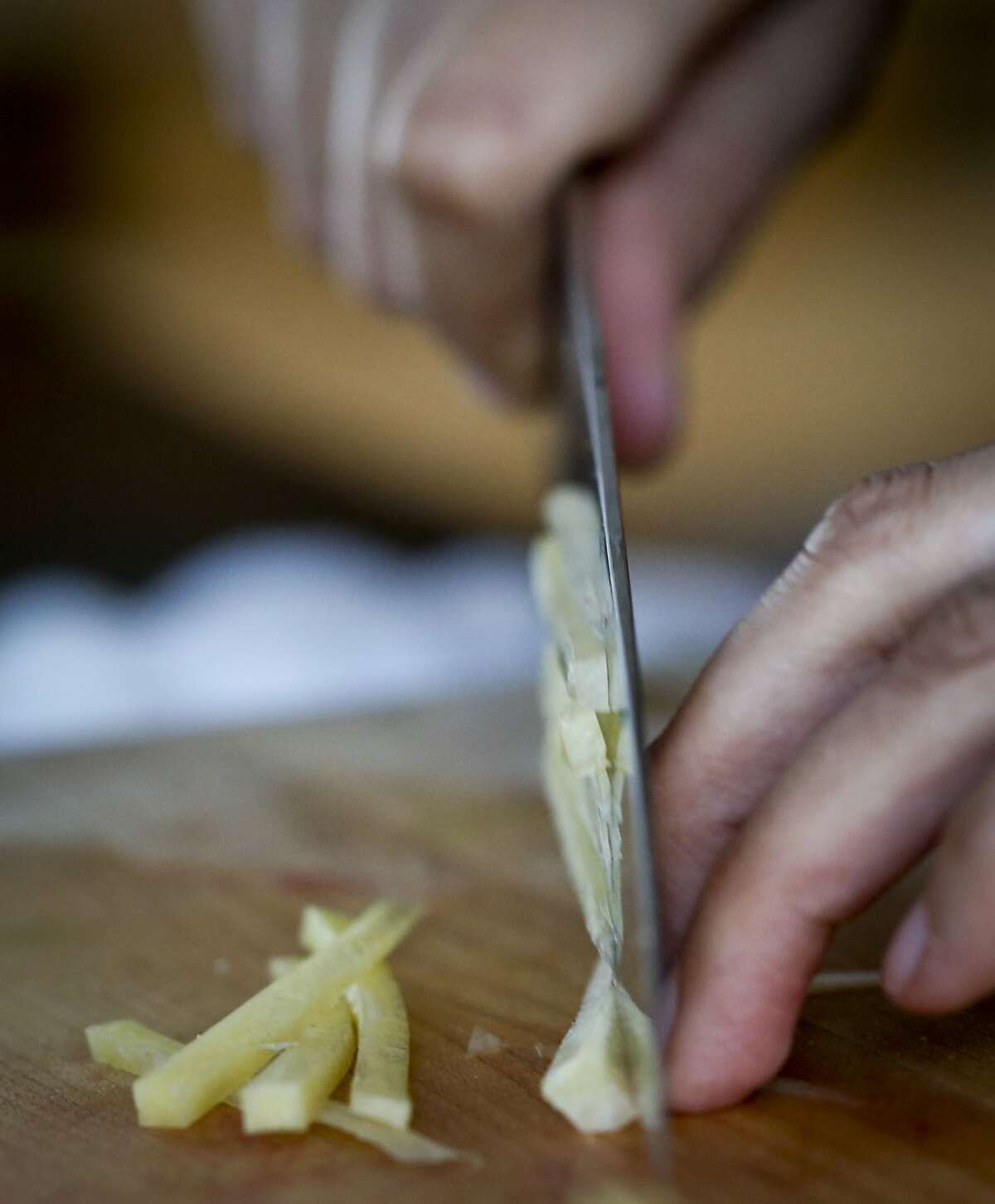 Chef Silvia McCollow of Nido in Oakland, Calif., slices jicama for her Aguachile Verde Ceviche on Monday, April 7, 2014.