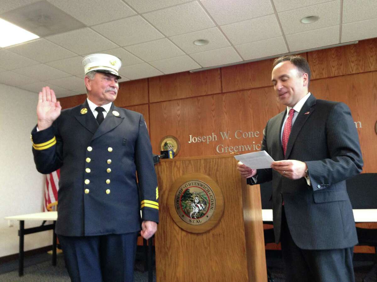 First Selectman Peter Tesei administers the oath of office to new Fire Marshal Shawn McDonnell at Town Hall Wednesday.