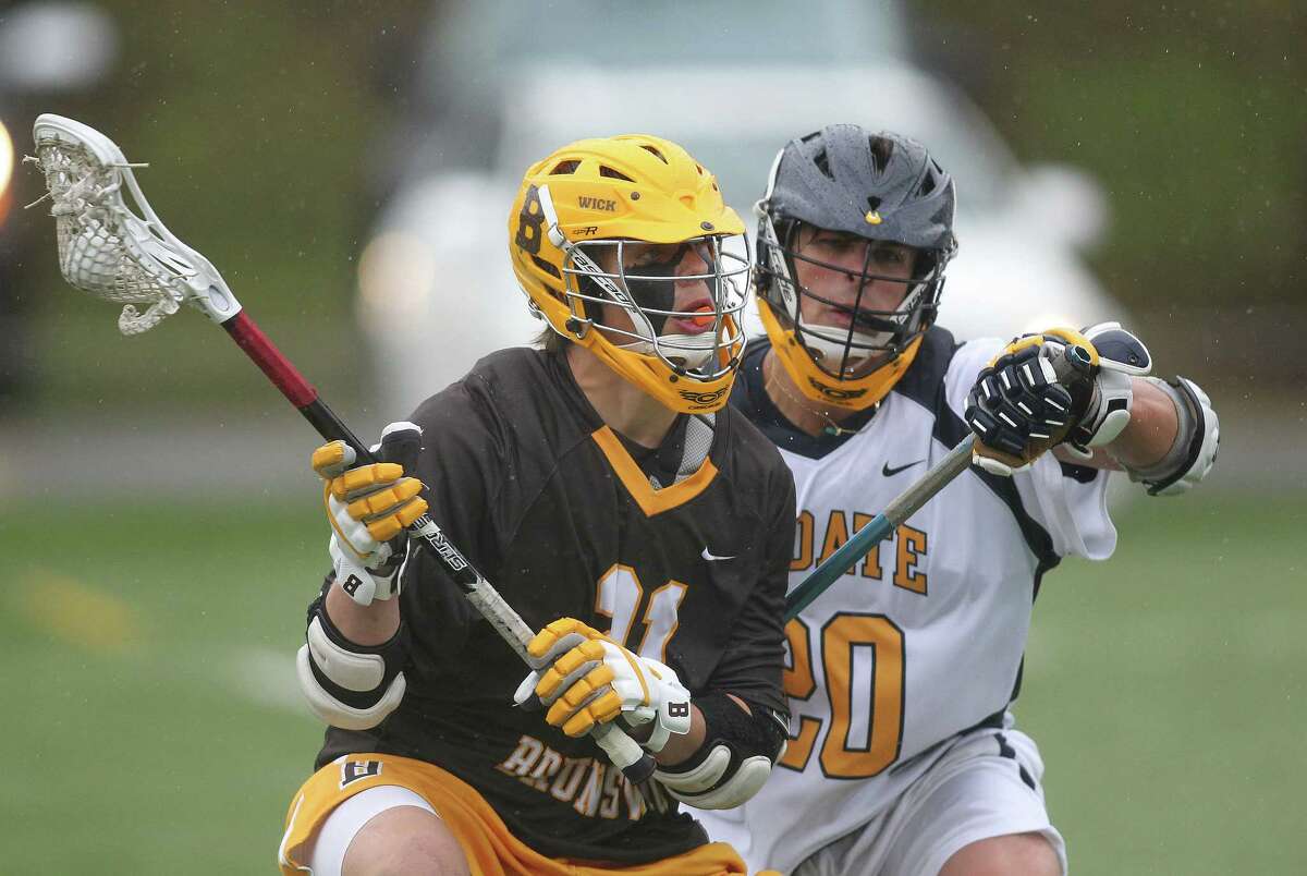 Brunswick middie John Fox looks for cutting room while guarded by Choate's Cameron Rasco during a home lacrosse game on Wednesday. Brunswick won the lacrosse battle , 5-2 in a weather affected game.