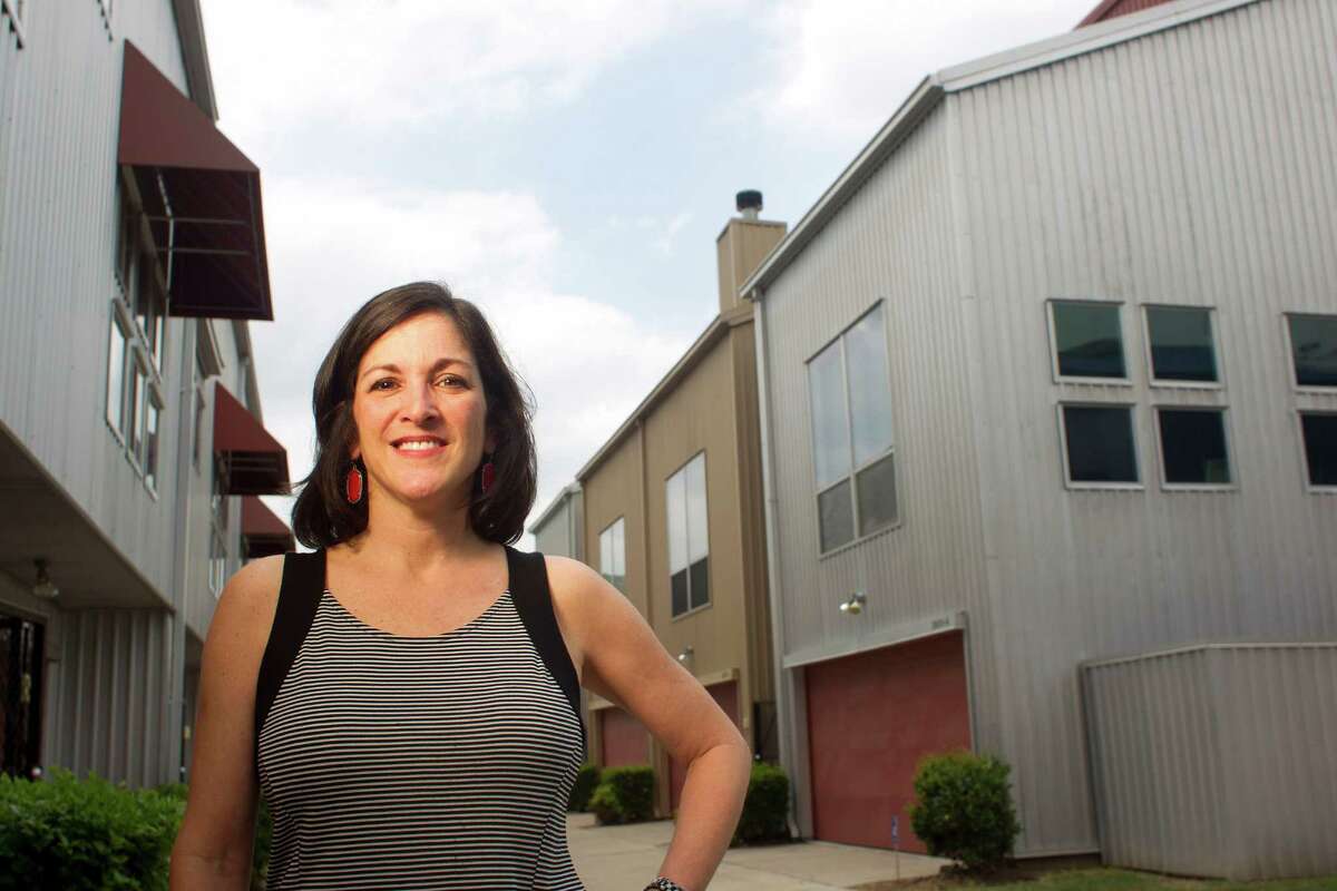 Taylor Nussbaum outside her home in the Calumet Street Lofts in the Riverside Terrace neighborhood just southeast of downtown Friday, April 25, 2014, in Houston. Nussbaum, who purchased her townhome in February, said there is now another similar town home her complex for sale for more than $40,000 than what she paid for her home. ( Johnny Hanson / Houston Chronicle )