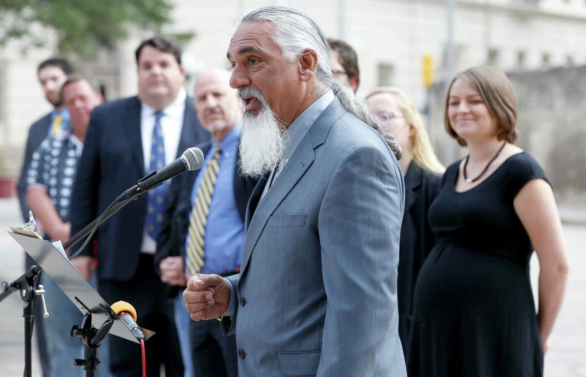 FILE - Jamie Balagia, at microphone, speaks Thursday May 1, 2014 in front of the Alamo during a news conference. The San Antonio lawyer known as the "DWI Dude" and "420 Dude" has been charged by the FBI with conspiracy to commit money laundering and obstruction of justice in an alleged plot that scammed about $1.2 million from Colombian clients.