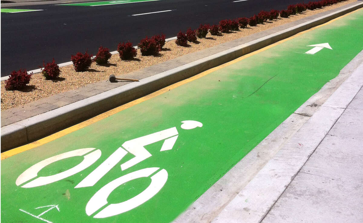 The new Polk contraflow bikeway is physically protected, offering a barrier between people biking and driving.