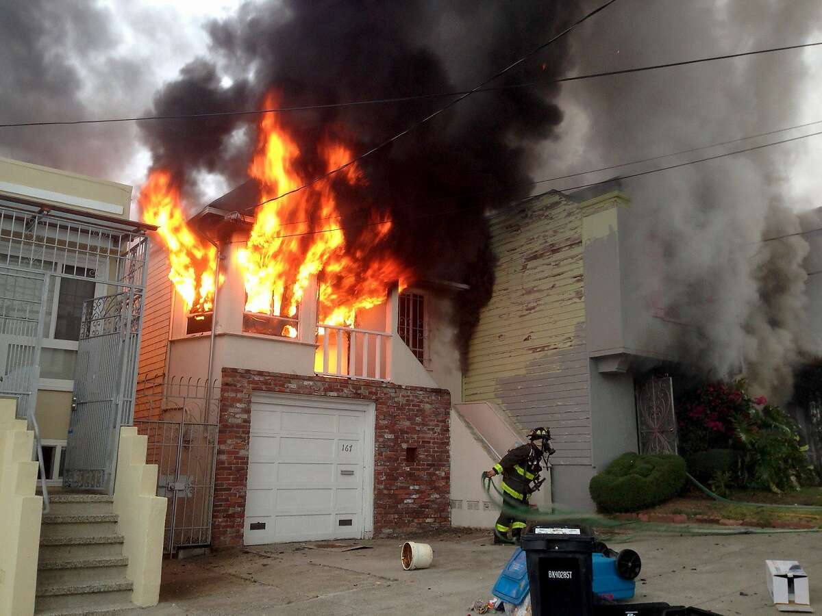 One of five homes damaged Friday morning in a fire in San Francisco's Oceanview neighborhood is shown totally involved in flames in this photograph by a Tianxing Wang, a neighbor whose home was also damaged.