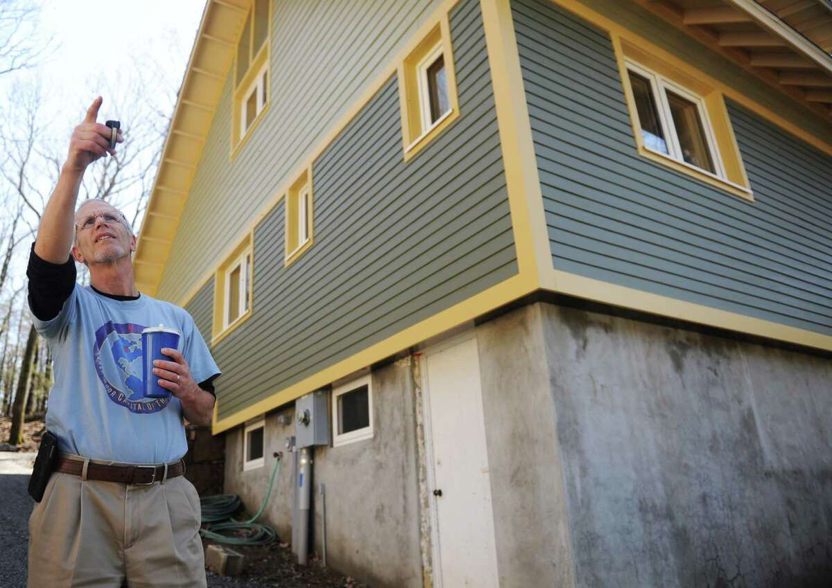 Local builder and home owner Mike Troelle shows off his energy-efficient home near Waubeeka Lake in Danbury, Conn. Thursday, May 1, 2014. Troelle is one of the winners of Connecticut's Zero Energy Challenge for modifications he made to his home during a major renovation project.