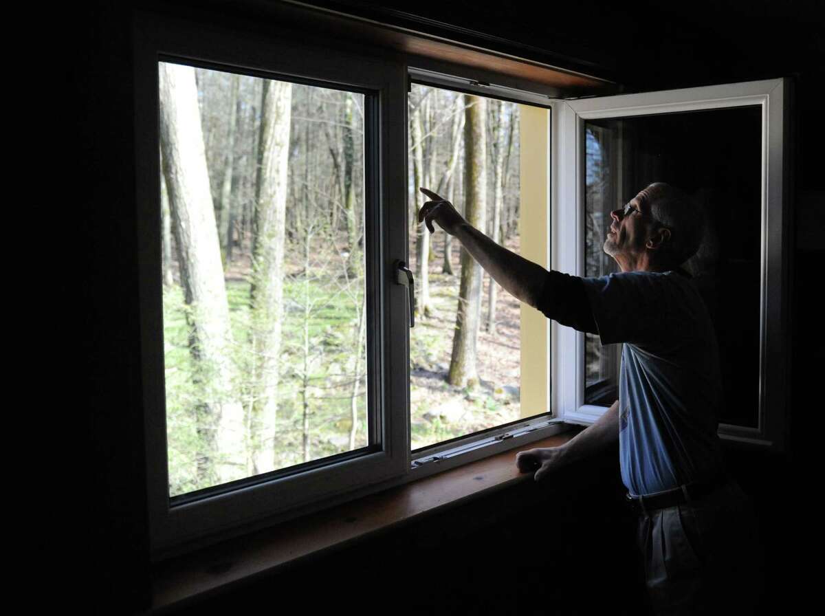 Local builder and home owner Mike Troelle shows off his insulating European-style windows in his energy-efficient home near Waubeeka Lake in Danbury, Conn. Thursday, May 1, 2014. Troelle is one of the winners of Connecticut's Zero Energy Challenge for modifications he made to his home during a major renovation project.