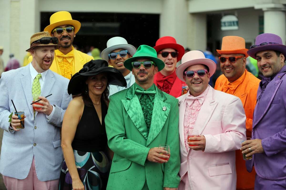 A group of fans in colorful hats and suits are seen in the paddock before the third race of the day at Churchill Downs Saturday, May 4, 2013, in Louisville, Ky. Today is the 139th running of the Kentucky Derby. (AP Photo/Gregory Payan)