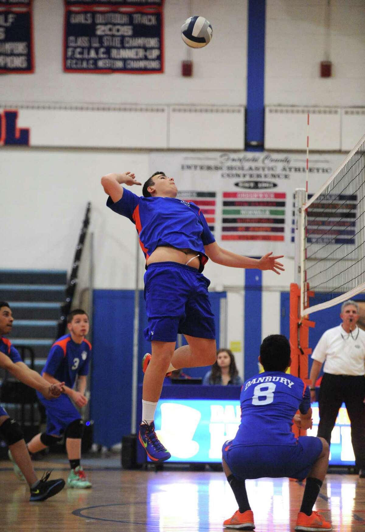 Danbury's Owen Smith spikes the ball after a set by teammate Alex Cardenas, right, in Danbury's 3-1 win over Greenwich at Danbury High School in Danbury, Conn. Friday, May 2, 2014.