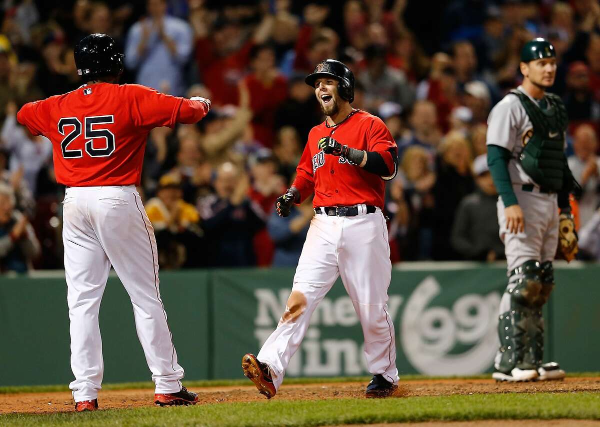 BOSTON, MA - MAY 2: Dustin Pedroia #15 of the Boston Red Sox celebrates with teammates after he hit grand slam home run in the sixth inning against the Oakland Athletics at Fenway Park on May 2, 2014 in Boston, Massachusetts. (Photo by Jim Rogash/Getty Images)