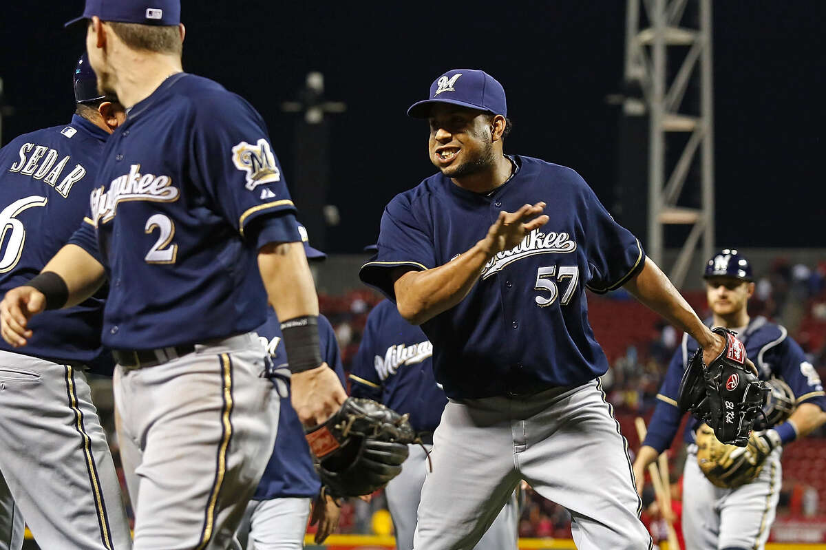 CINCINNATI, OH - MAY 2: Third Base Coach Ed Sedar #6 congratulates Francisco Rodriguez #57, both of the Milwaukee Brewers after coming in and pitching for the save against the Cincinnati Reds at Great American Ball Park on May 2, 2014 in Cincinnati, Ohio. Milwaukee defeated Cincinnati 2-0.