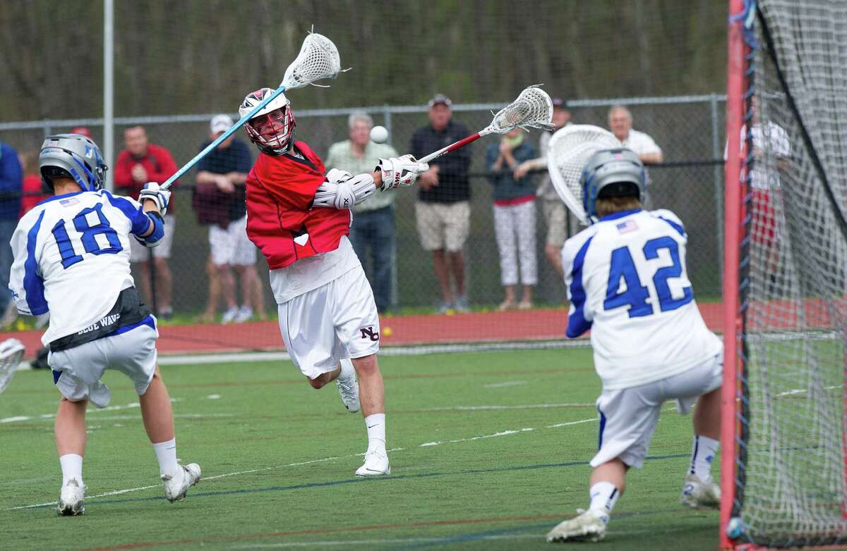 New Canaan's Justin Meichner takes a shot during Saturday's boys lacrosse game in Darien, Conn., on May 3, 2014.
