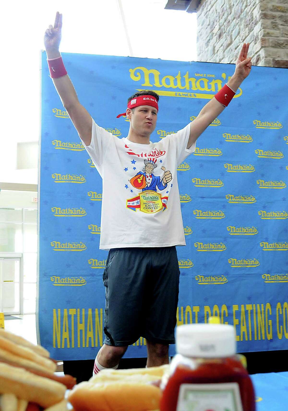 Mens favorite Erik "The Red" Denmark takes the stage at the Nathan's Famous Hot Dog Eating Contest regional qualifier at Memorial City Mall Saturday May 03, 2014.(Dave Rossman photo)