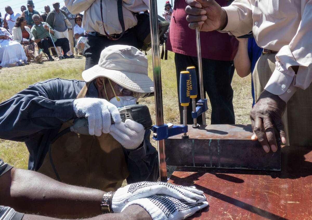 A time capsule recovered from the burned remains of the old Childress Memorial Church of God in Dignowity Hill is opened during the groundbreaking ceremony at the church's new location on Binz-Engelman on Saturday, May 3, 2014. The capsule dates to 1908.