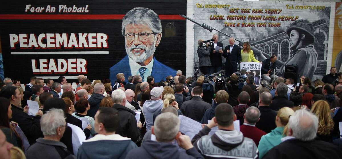 Sinn Fein party members rally in protest of the detention of leader Gerry Adams, being questioned about the 1972 murder of Jean McConville and his involvement in the Irish Republican Army, in West Belfast, Northern Ireland.