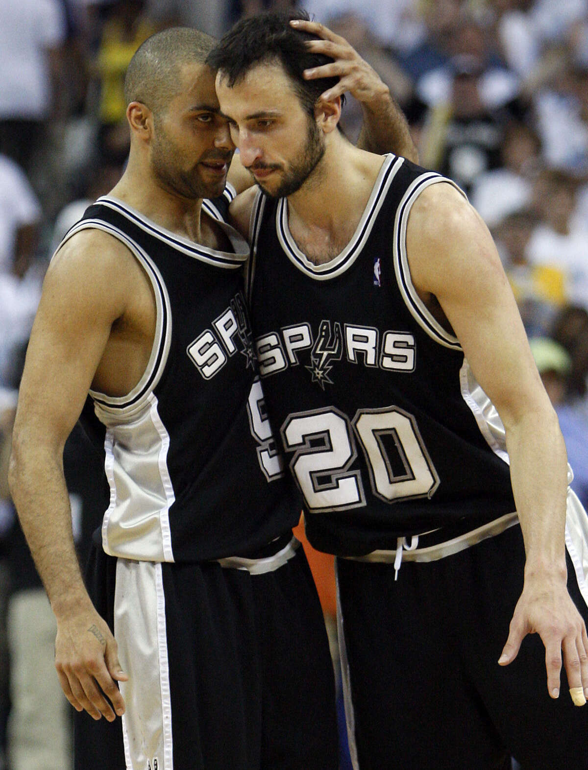 Tony Parker and Manu Ginobili embrace after beating the Hornets in Game 7 in 2008.