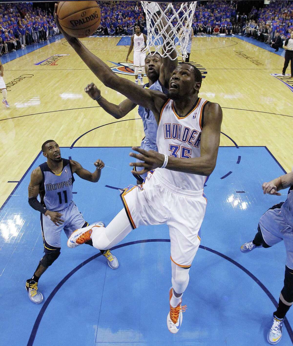 OKC's Kevin Durant puts up a shot against Memphis inside. Durant had 33 points and eight boards, and Russell Westbrook added a triple-double of 27 points, 16 assists, 10 rebounds.