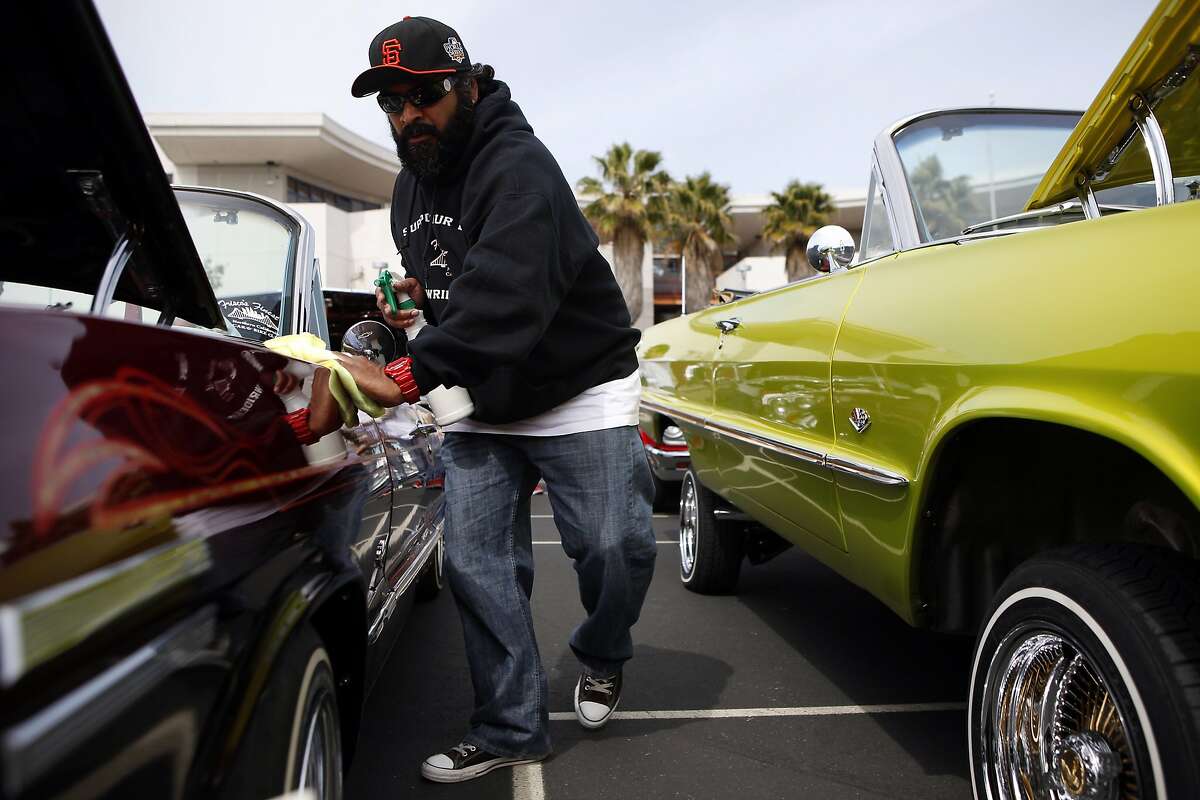 Ron Prasad polishes his 1963 Chevy Impala during a low rider car show benefit fundraiser at John O'Connell High School in San Francisco, CA, Sunday May 4, 2014.