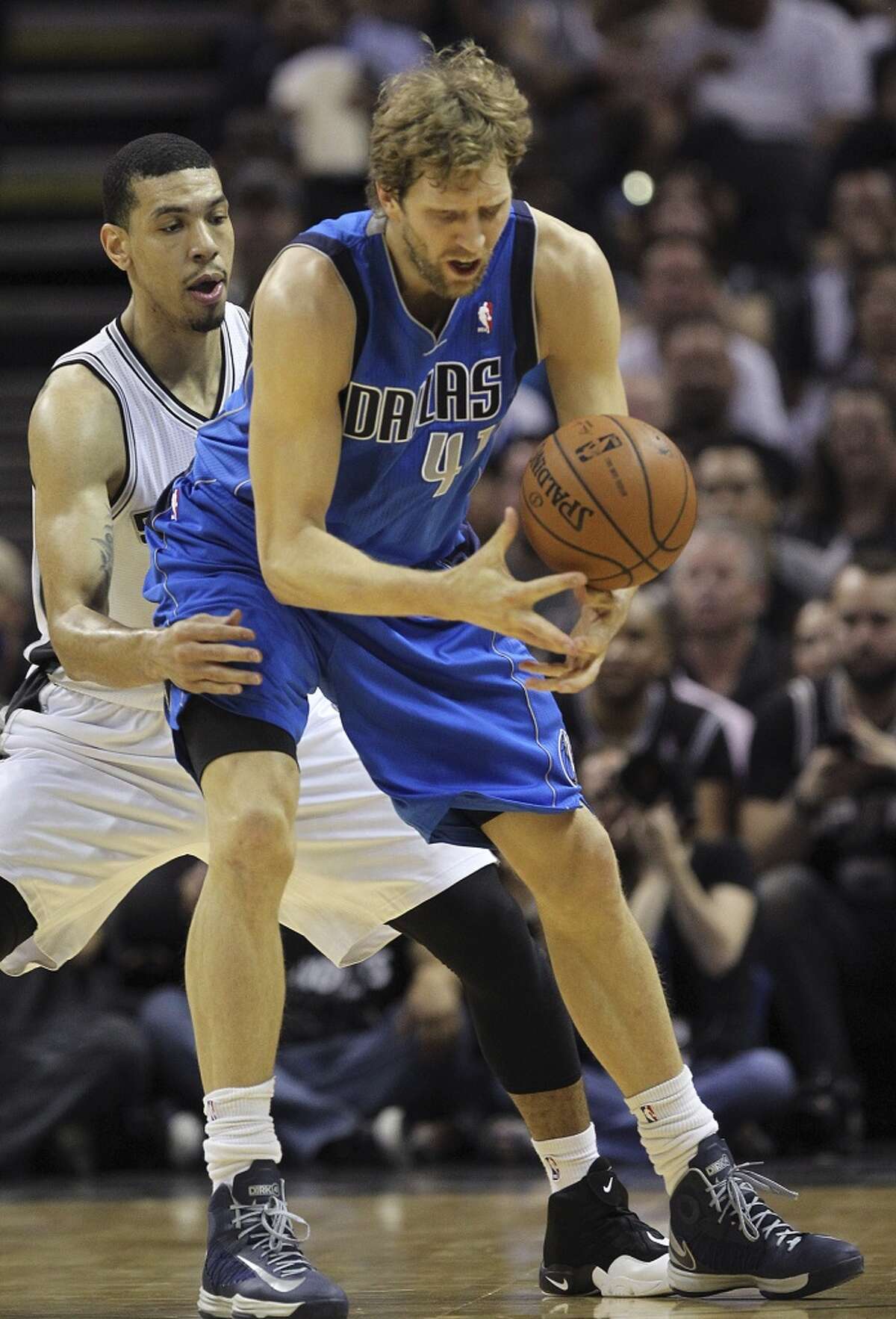 Dallas Mavericks' Dirk Nowitzki tries to get control of the ball as San Antonio Spurs' Danny Green defends during the first half of game seven in the first round of the Western Conference Playoffs at the AT&T Center, Sunday, May 4, 2014.