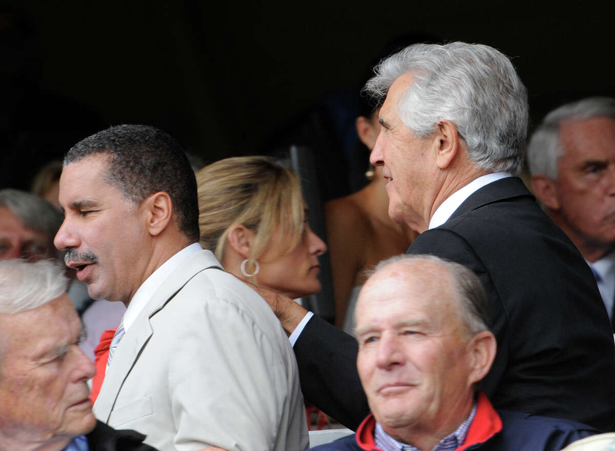 Governor David Paterson is pushed through the crowd by ex Senator Joseph Bruno before the 140th running of The Travers at the Saratoga Race Course in Saratoga Springs, New York August 29, 2009.