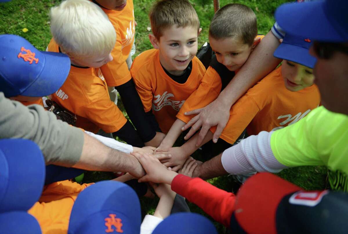 The Mets Rookie League team gathers after its game in the Danbury Athletic Youth Organization T-Ball League at the King Street Elementary School fields in Danbury, Conn. Saturday, May 3, 2014. DAYO T-Ball is for boys and girls four to seven years old and is split into three divisions to help the kids progress with children of similar age and ability.