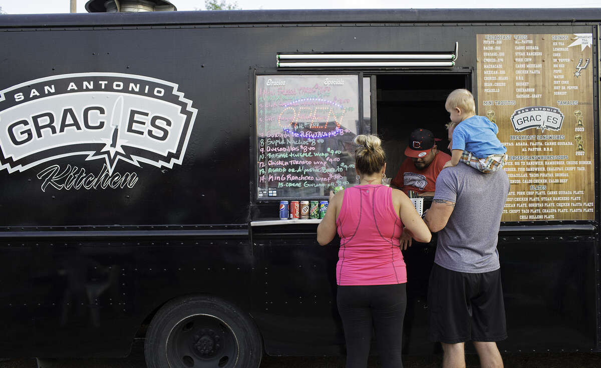 Felicia, Gary and son Chase Armstrong place their orders at Gracie's Kitchen food truck at a "Boardwalk on Bulverde" event in August 2013. The Food Truck Roundup in Cibolo May 10 will feature similarly served cuisine.