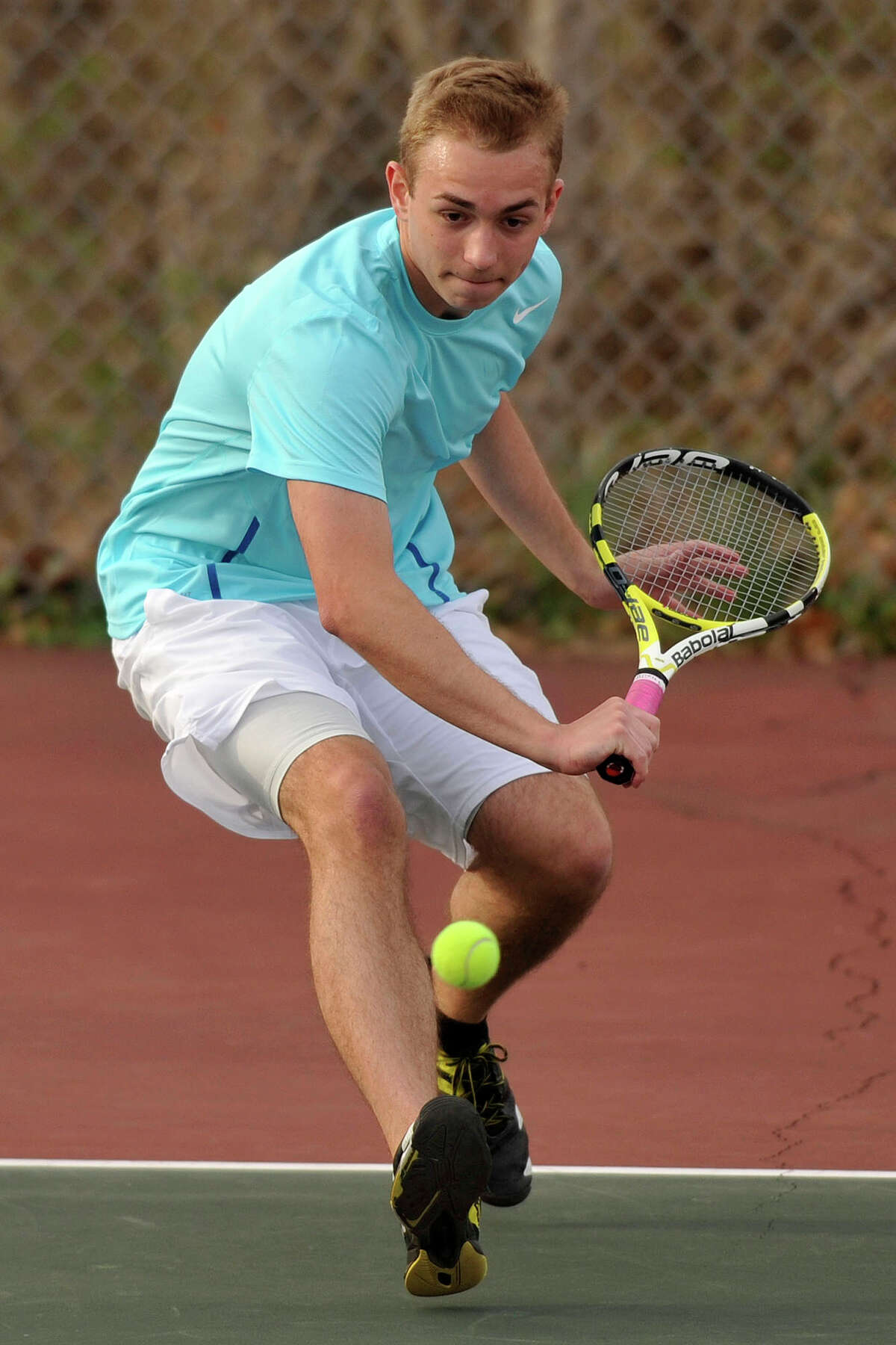Darien's Harrison Walter returns the ball during a tennis match at Greenwich High School on Monday, April 14, 2014.