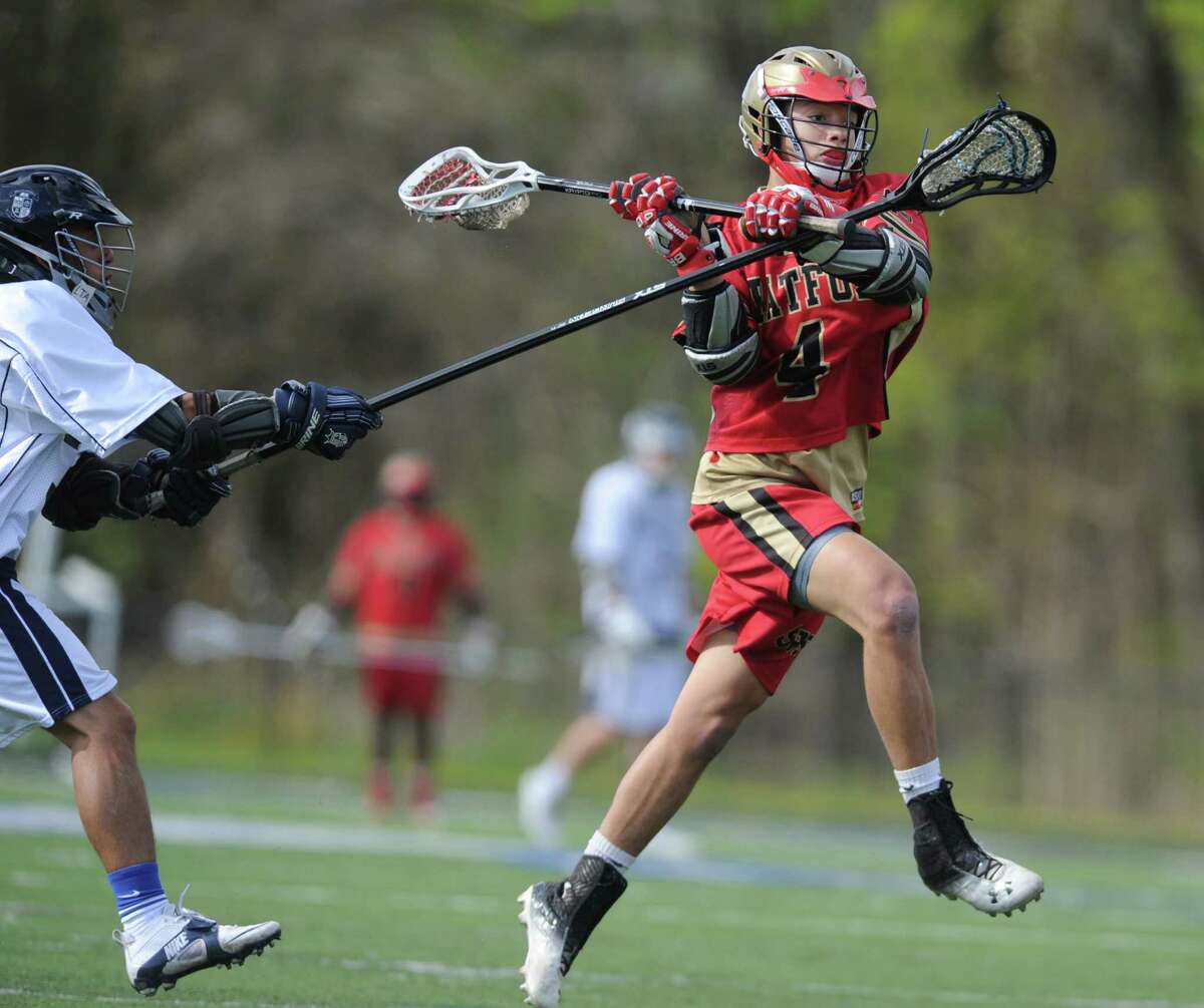 Stratford's Isaiah Booker, right, shoots past Immaculate defender Dillon Silva in the high school boys lacrosse game between Immaculate and Stratford at Immaculate High School in Danbury, Conn. Tuesday, May 6, 2014.