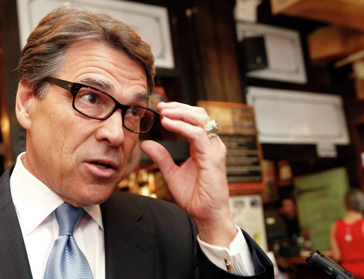 FILE - In this April 23, 2014 file photo, Texas Gov. Rick Perry speaks to the media after meeting with business owners in New York. Gov. Perry says Tuesday, May 6, 2014, that he never tried making a deal with an Austin district attorney about vetoed state funding that is now the focus of a grand jury investigation. Perry said Tuesday that he would let the case “play out its course” as a grand jury in Austin considers whether the possible 2016 Republican presidential candidate abused his power last summer. (AP Photo/Kathy Willens, File)