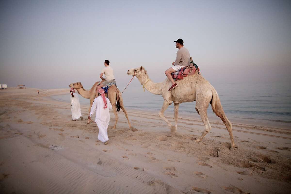 Richard III cast members Chandler Williams (left) and Kevin Spacey take a camel ride in the desert whilst on tour in Doha, Qatar, in, "Now: In the Wings on the World Stage."