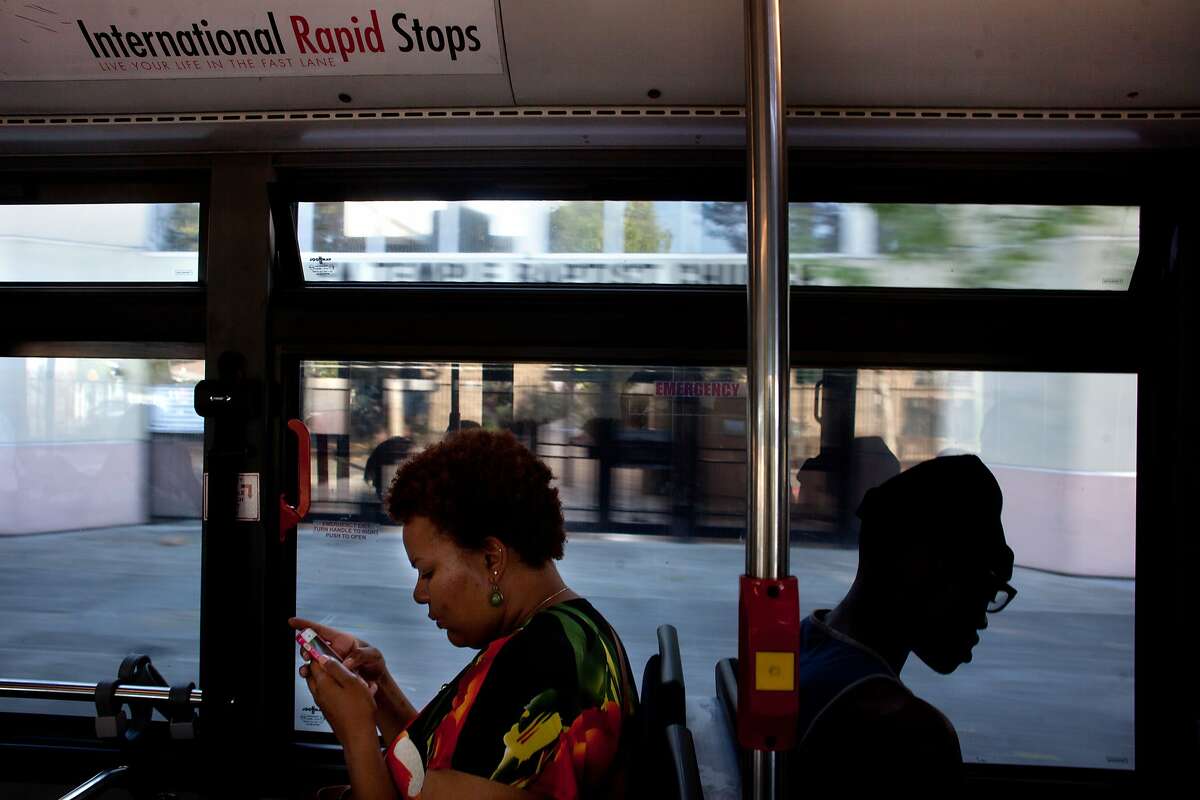 Mia Salter, left, and Kevin Newton, 16, right, ride the AC Transit 1R bus line home from school in Oakland, Calif. on Thursday, May 1, 2014. The 1R, which stands for rapid, is the predecessor to the bus rapid transit system that is slated to be built along International Boulevard. The BRT system will run more like a subway and will have dedicated lanes or stations. The new system has stalled due to public resistance to taking away a lane or two of traffic and eliminating parking. Salter said since the bus runs through a high crime area, the bus often has to take detours. "It gets so backed up sometimes, it's ridiculous." Salter said.