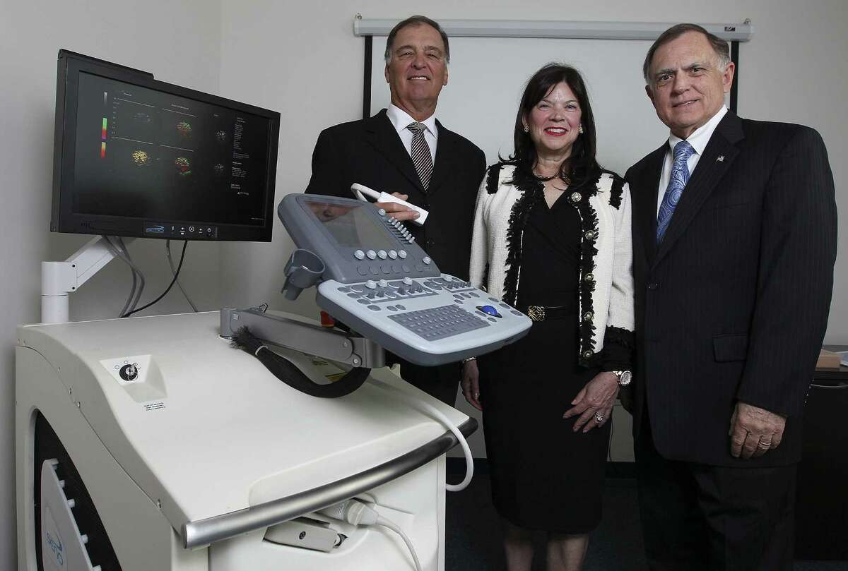 Leaders of Seno Medical Instruments — medical director Dr. A. Thomas Stavros (left), CEO and founder Janet Campbell-Clark and President Tom Miller — show the company's Imagio optoacoustic imaging system, designed to diagnose breast cancer.