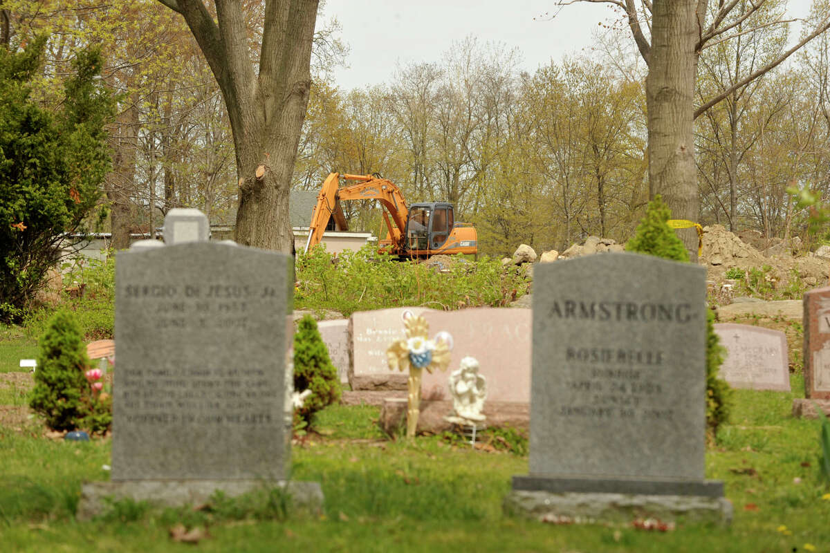 An excavator is seen in the waterfront area of Woodland Cemetery in Stamford, Conn., on Wednesday, May 7, 2014, where a number of trees have been taken down in the past few months.