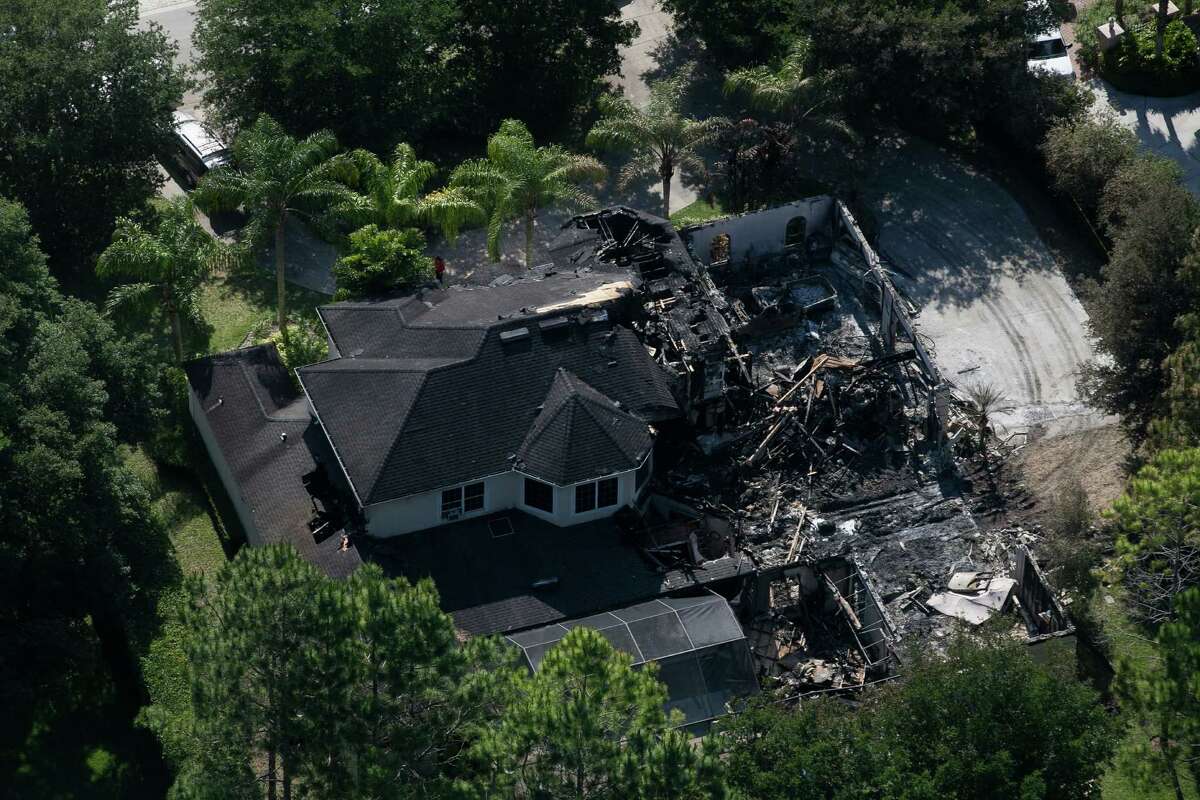 This aerial photo shows the burned out home on Thursday, May 8, 2014 in Tampa, Fla. Authorities have said they think the fire at the five-bedroom home was intentionally set and that they found fireworks inside the home. Police have not said how the blaze started or who might be responsible. The home, which is owned by former tennis star James Blake, was engulfed in flames when firefighters responded Wednesday morning. Neighbors told police they heard explosions coming from it. Blake was renting the house to the a family and was not there at the time. (AP Photo/The Tampa Bay Times, Eve Edelheit) TAMPA OUT; CITRUS COUNTY OUT; PORT CHARLOTTE OUT; BROOKSVILLE HERNANDO TODAY OUT