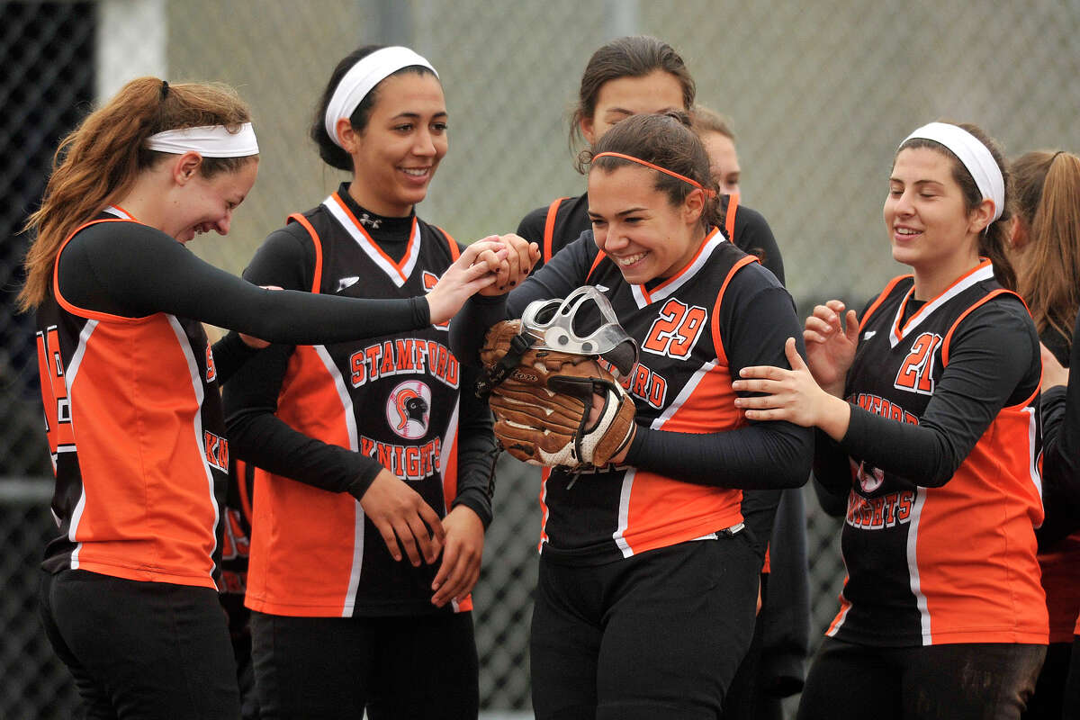 Stamford's Christina Joaunou, second from left, is congratulated by her team mates after making a successful closing effort during their softball game against Staples at Bedford Middle School in Westport, Conn., on Thursday, May 8, 2014. Stamford won, 10-1