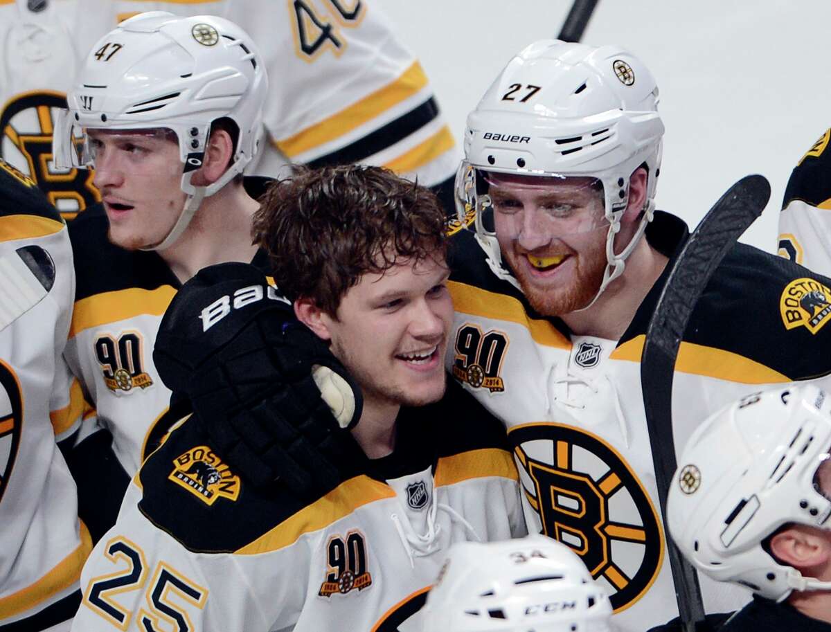 Boston Bruins' Matt Fraser (25) celebrates with teammate Dougie Hamilton after scoring the winning goal against the Montreal Canadiens during the first overtime period in Game 4 in the second round of the NHL Stanley Cup playoffs Thursday, May 8, 2014, in Montreal. (AP Photo/The Canadian Press, Ryan Remiorz) ORG XMIT: RYR111