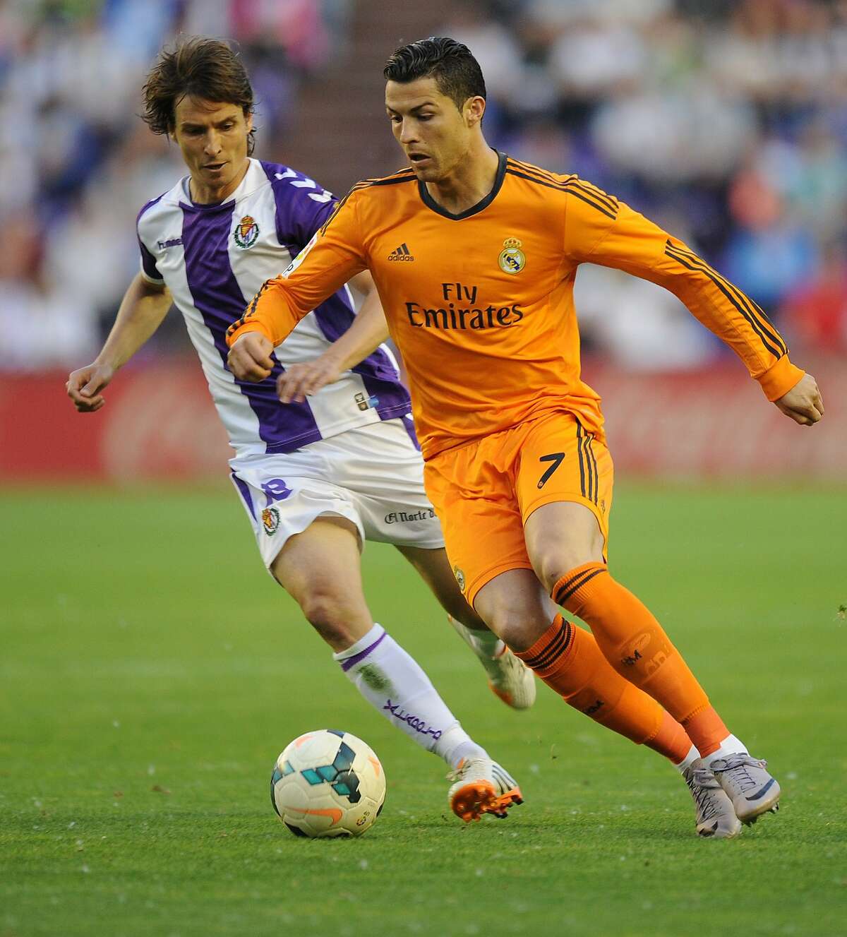 Real Madrid's Portuguese forward Cristiano Ronaldo, right, vies for the ball with Valladolid's Diego Marino, during a Spanish La Liga soccer match at the Jose Zorrilla stadium in Valladolid, Spain, Wednesday, May 7, 2014. (AP Photo/Israel L. Murillo)