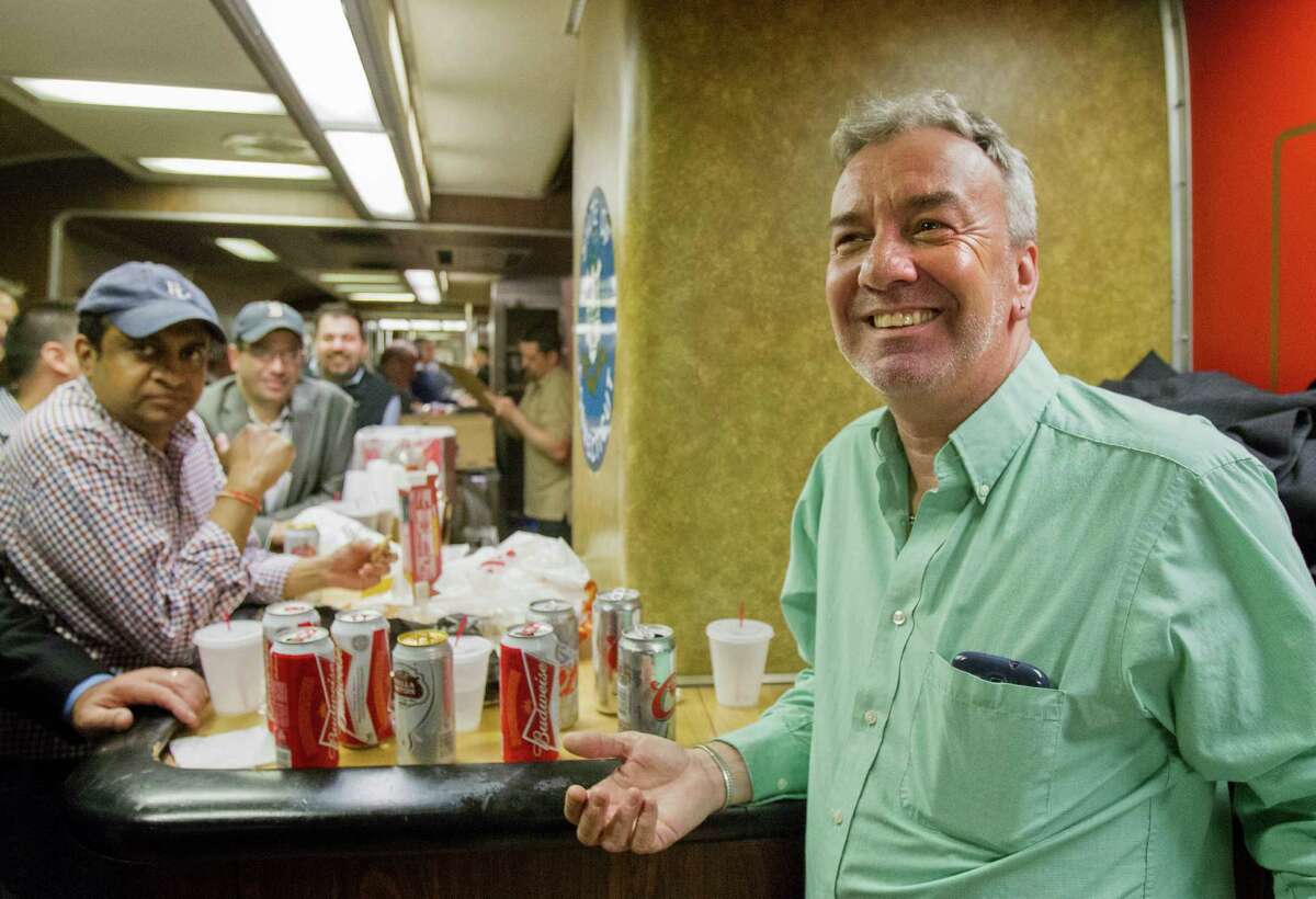 Mark DeMonte, right, of Wallingford, Conn., join other riders in the bar car on the 7:07 p.m. train to New Haven, Conn., at Grand Central Terminal on Thursday, May 8, 2014 in New York. DeMonte, a bar car regular, has been dubbed "Mayor of the 5:48" by friends and riders of his usual train. Metro-North is retiring bar cars from the New Haven Line after Friday's afternoon rush hour. They were the last commuter bar cars in the U.S. (AP Photo/Michael R. Sisak) ORG XMIT: NYMS103