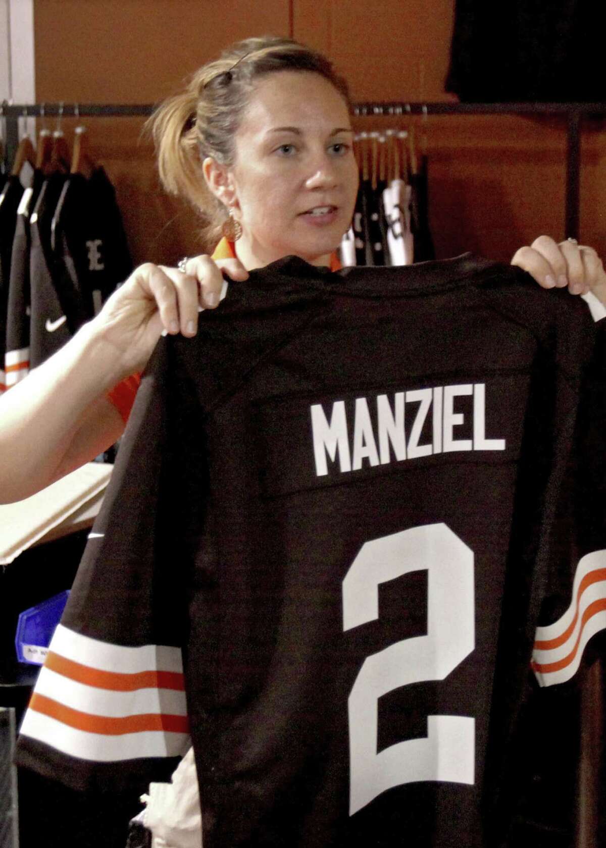 Bethany Davis holds up a Browns' Johnny Manziel jersey for a customer in Cleveland.