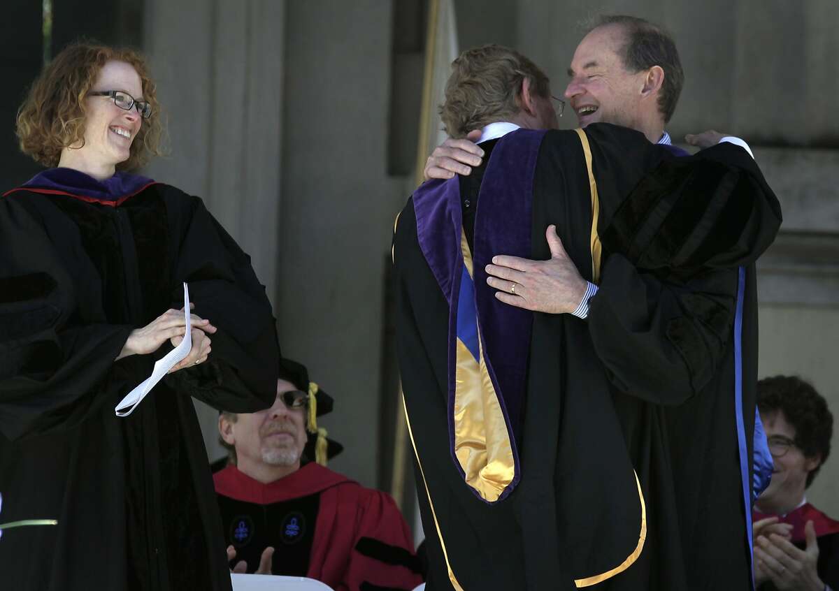 David Boies (right) and Ted Olson hug after the legal team's address to UC Berkeley Law School graduates at the Greek Theatre in Berkeley, Calif. on Saturday, May 10, 2014. At left, is the school's acting dean Gillian Lester. Boies and Olson, who successfully argued the case against Prop. 8 and was overturned by the U.S. Supreme Court, were the guest speakers at the commencement ceremony.