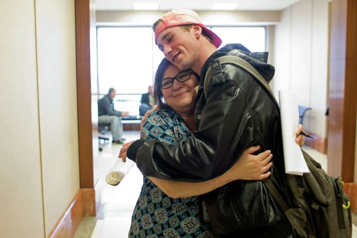 Ryan Stapp, 22, gets a hug from Sober Court Coordinator Rachael Ferrel, ﻿at the Harris County Criminal Justice Center﻿﻿. Stapp ﻿is a recent graduate of the county's Saving Ourselves By Education & Recovery (S.O.B.E.R.) DWI program. ﻿