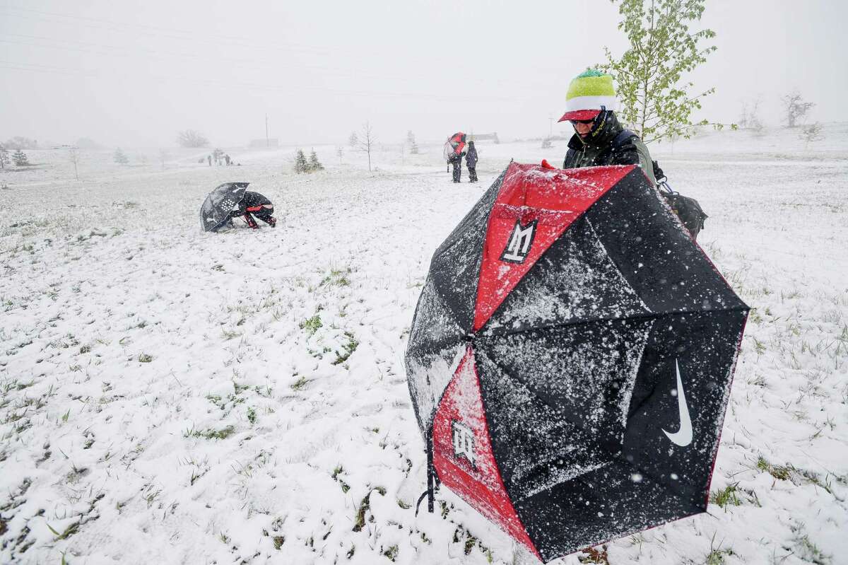 Keith Vest competes in a disc golf tournament Sunday, May 11, 2014, at Aggie Greens in Fort Collins, Colorado. Snow is expected to fall through Monday, with highs reaching the sixties later this week. (AP Photo/The Coloradoan, Erin Hull)