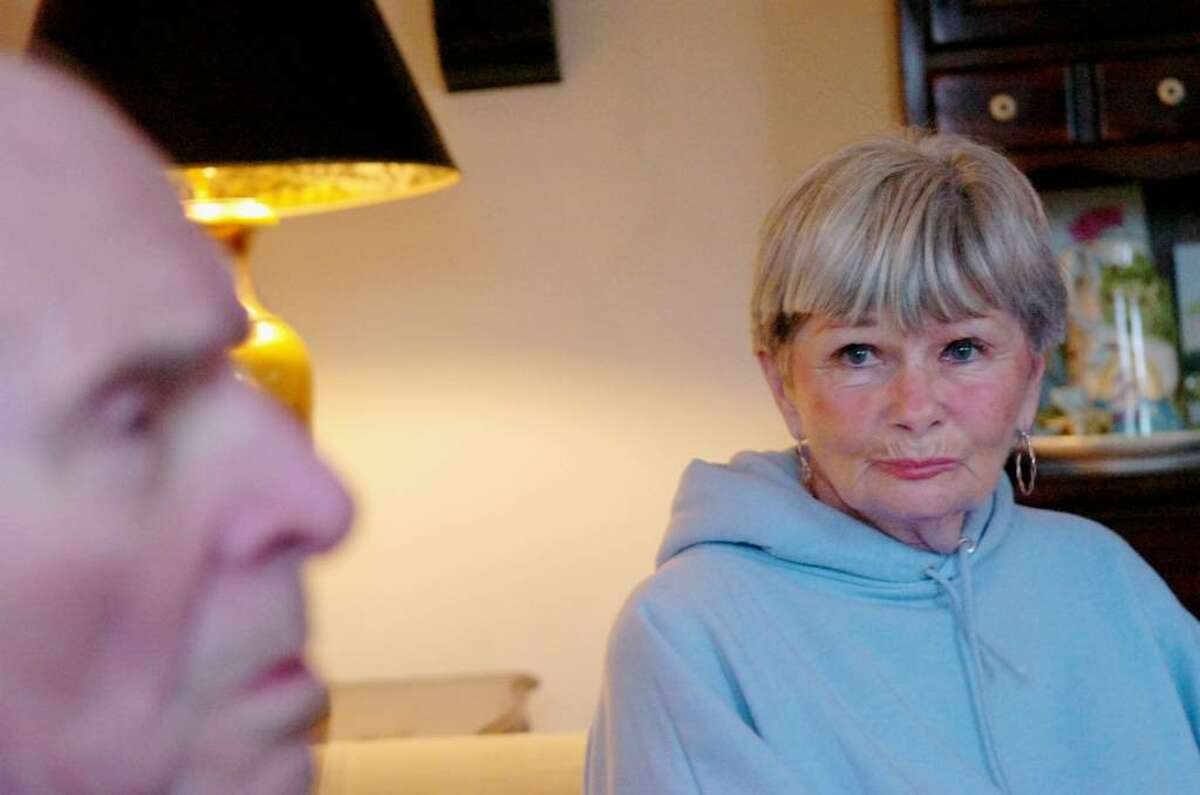 B.J. Hocter eyes her husband, Don, in their Cos Cob home Tuesday afternoon, February 9, 2010. Don Hocter, 82, is in the late stage of Alzheimer's disease which leaves him completely dependent on his wife.