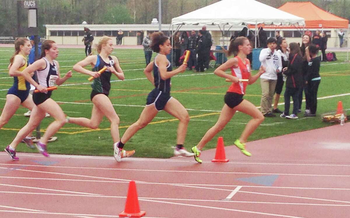 Staples junior Erica Hefnawy, center, runs in the first leg of the distance medley relay event held at the Loucks Games May 8 in White Plains, N.Y.