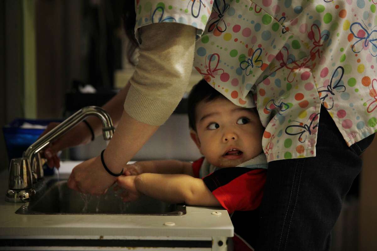 Angel Flores, 1, gets help washing his hands in the infant room after a snack at the Compass Children's Center on Monday, May 12, 2014 in San Francisco, Calif.