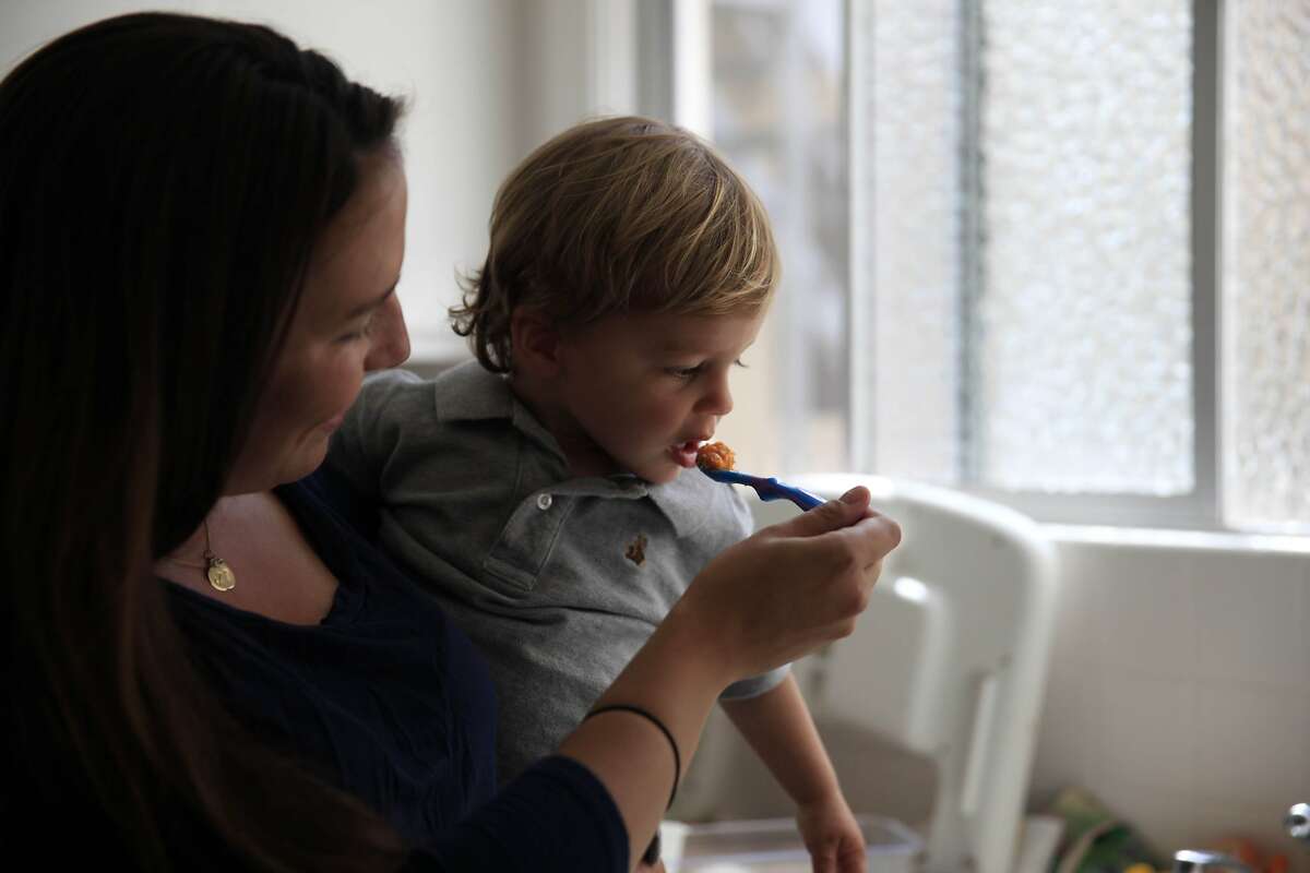 Jenn Phillips (l to r) of San Francisco gives her son Jack, 17 months, a taste of pureed sweet potatoes and apple on Friday, May 2, 2014 in San Francisco, Calif.