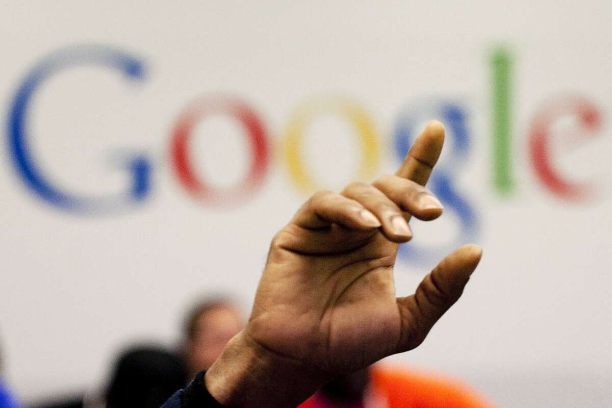 FILE - In this Oct. 17, 2012, file photo, a man raises his hand during at Google offices in New York. People should have some say over the results that pop up when they conduct a search of their own name online, Europe's highest court said Tuesday, May 13, 2014. (AP Photo/Mark Lennihan, File)